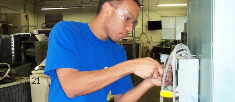 H V A C student learning to fix electrical componants at Brownson Technical School in California