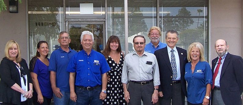 Group of Brownson Technical School Administrative Staff and H V A C Excellence staff standing in-front of the school 