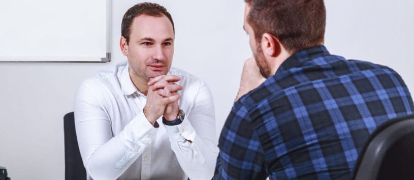 A student talks to a staff member about financial aid options 