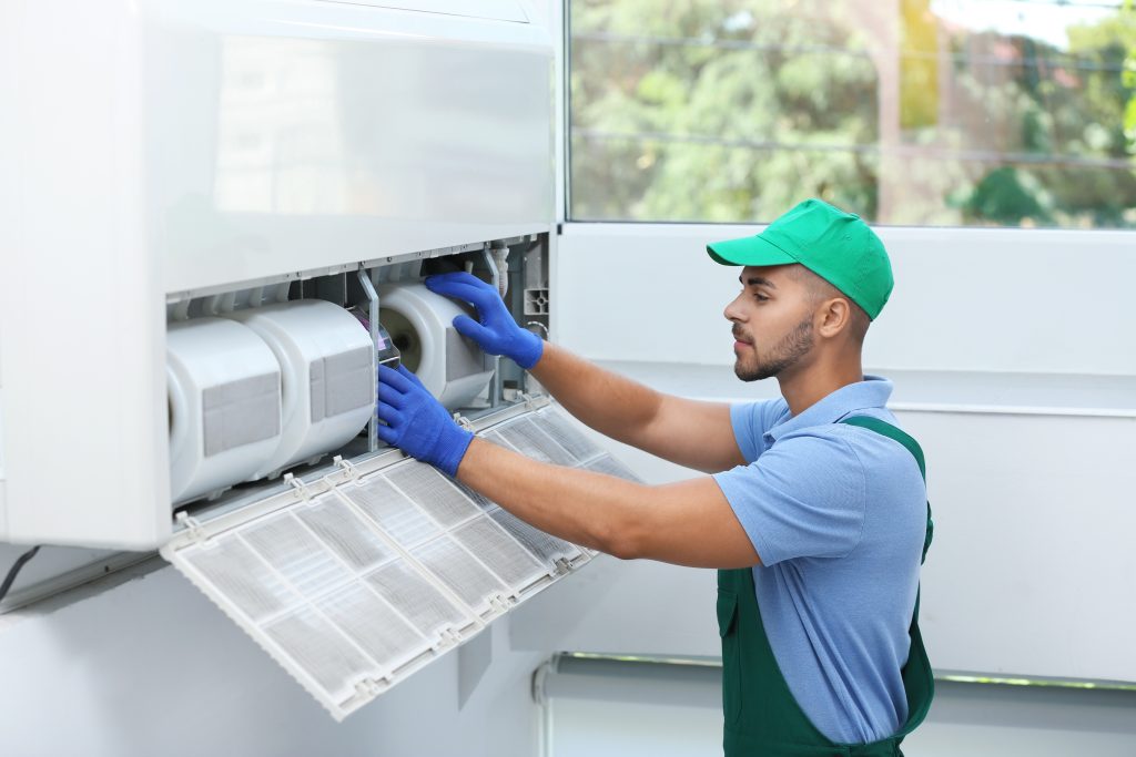 Man with working gloves changing a filter